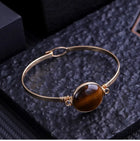 Bracelet "Force Solaire" – Jonc Doré & Perle Œil de Tigre Ovale